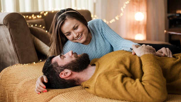 Foto grátis casal feliz em plano médio deitado na cama