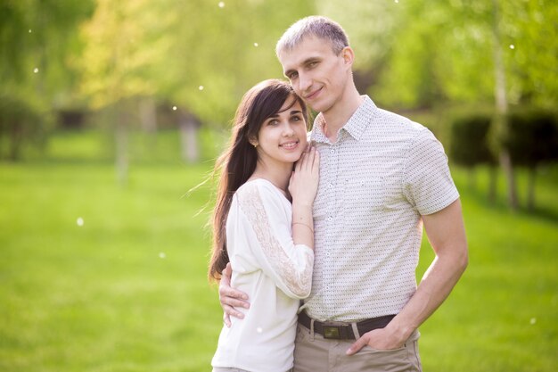 casal feliz posando ao ar livre