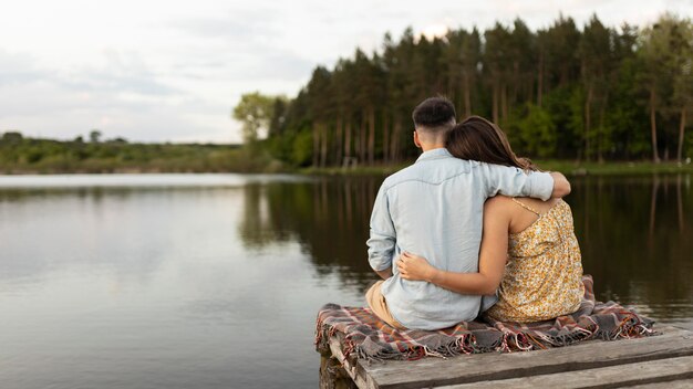 Casal filmado à beira do lago