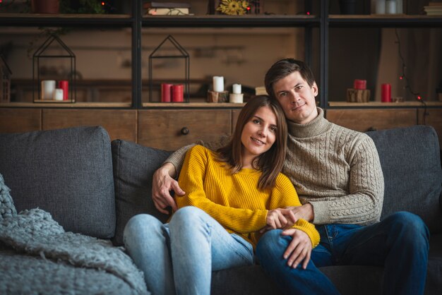 Casal fofo abraçados no sofá