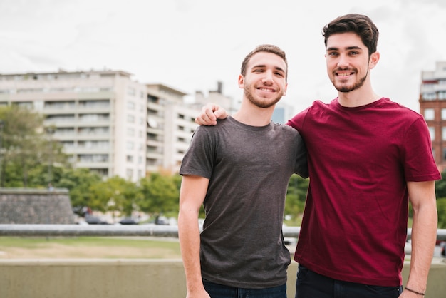 Casal gay feliz abraçando na rua