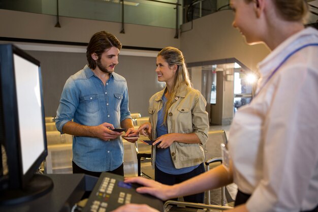 Casal interagindo um com o outro no balcão de check in