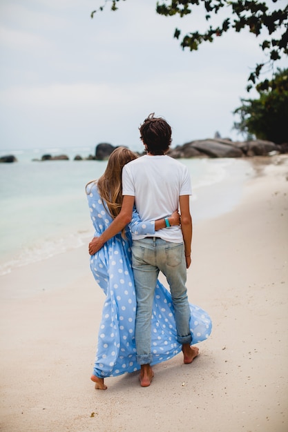 Casal jovem elegante e moderno apaixonado em uma praia tropical durante as férias