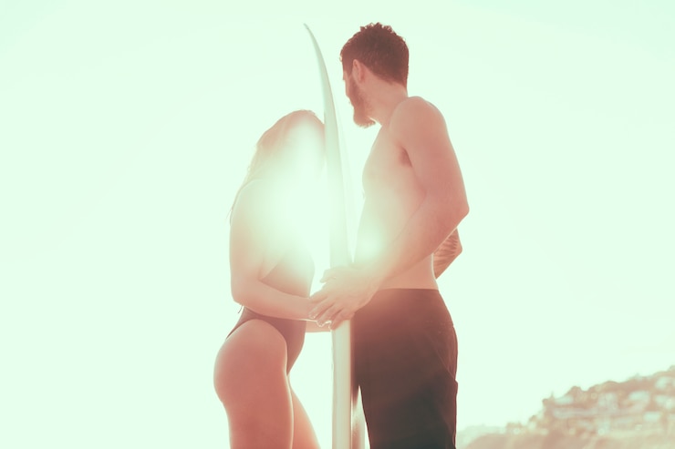 Foto grátis casal surfista na praia