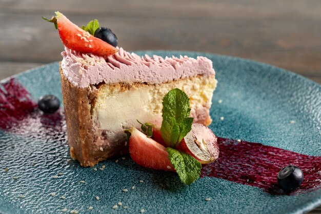 Cheesecake clássico com frutas vermelhas em prato decorado