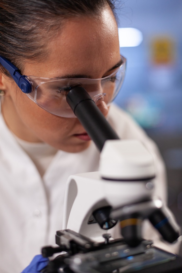 Foto grátis cientista experimental analisando amostra no microscópio