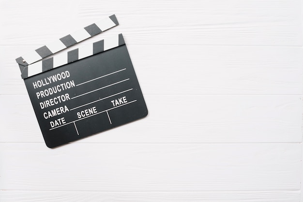 Clapperboard na mesa de madeira branca