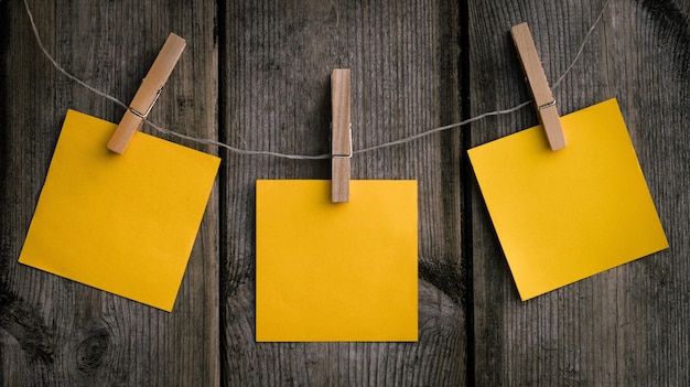 Foto grátis close de um papel amarelo pendurado em um clipe de madeira
