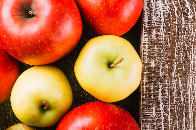 Foto grátis close-up de maçãs perto de prancha de madeira