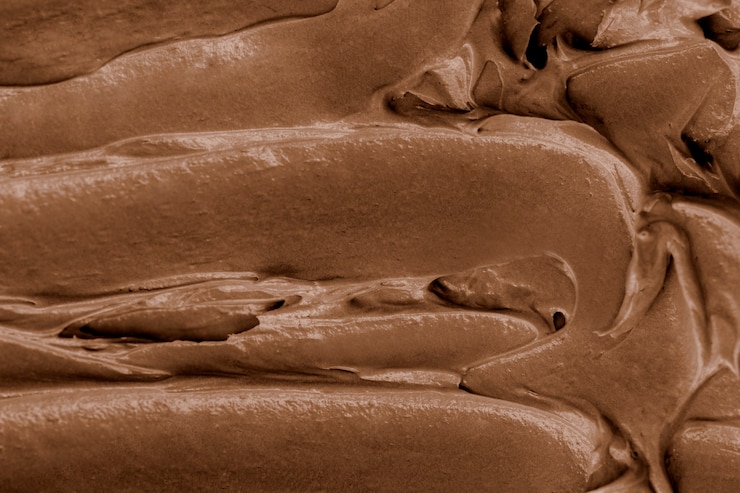 Foto grátis close-up do fundo da textura da cobertura de chocolate
