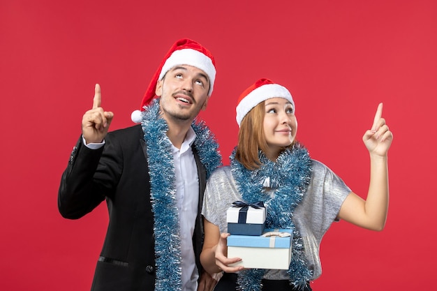 Close-up em um lindo casal jovem usando chapéu de Papai Noel isolado