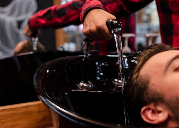 Close-up, lavando o cabelo na barbearia