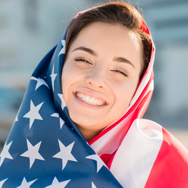 Foto grátis close-up, sorrindo, mulher jovem, segurando, grande, eua bandeira
