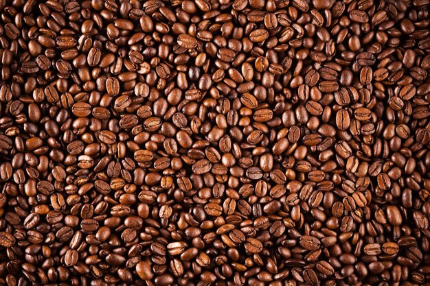 Closeup de textura de grãos de café. Café marrom, textura de fundo, closeup. Fundo agradável para suas idéias.