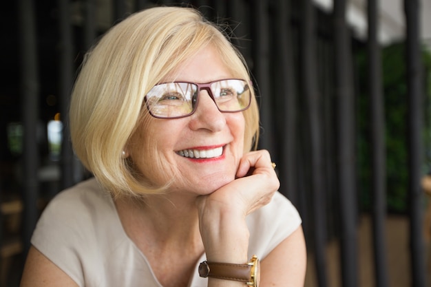 Closeup of Happy Attractive Senior Woman in Cafe