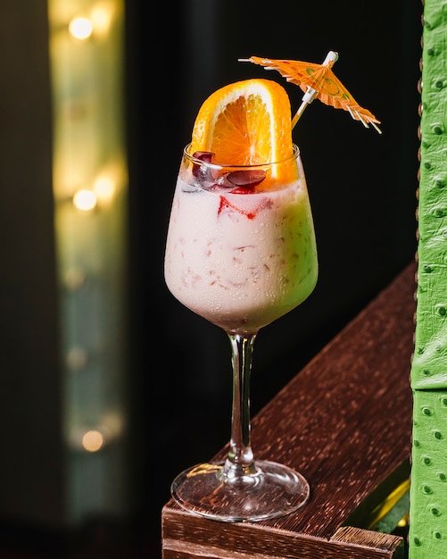 Cocktail de vista frontal com uma fatia de laranja e decoração