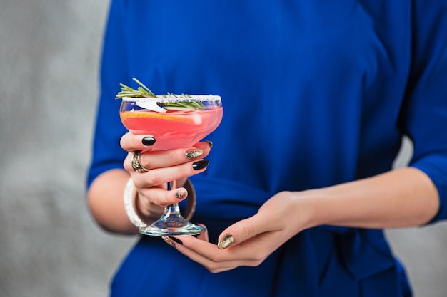 cocktail exótico e mãos femininas