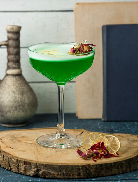 Foto grátis cocktail verde decorado com botões de rosa secos em vidro cristal