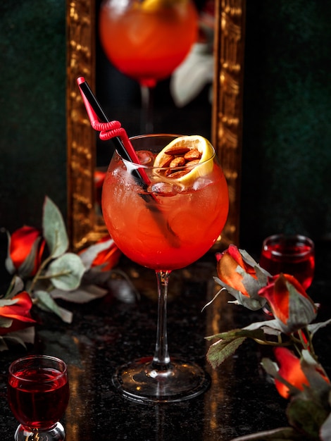 Cocktail vermelho com fatia de fruta