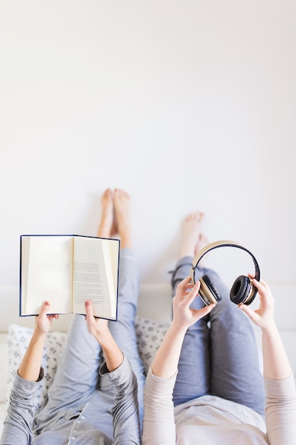 Colheita de mulheres com livro e fones de ouvido