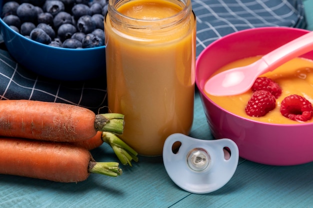 Foto grátis comida para bebe com cenoura e mirtilo em ângulo alto