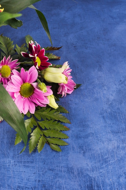 Composição de flores roxas e plantas tropicais