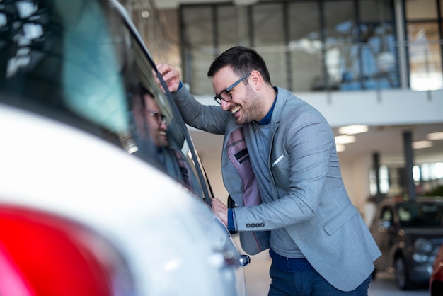 Comprador de carro escolhendo seu veículo favorito na concessionária