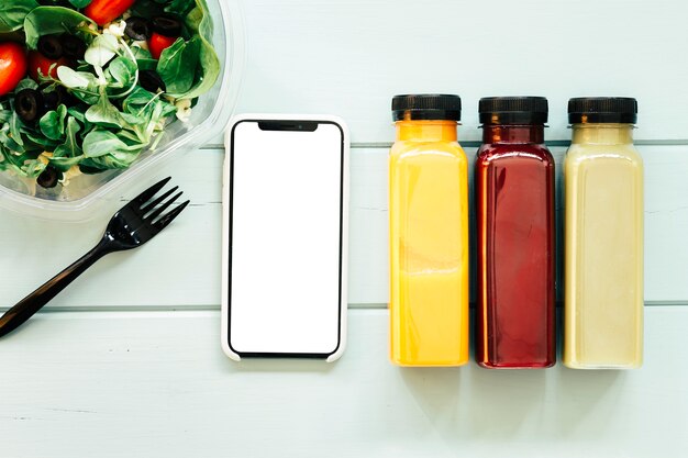 Conceito de comida saudável com smartphone ao lado de sucos