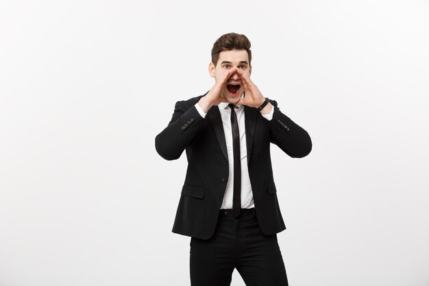 Conceito de negócio: jovem bonito homem de negócios gritando e isolado no branco.