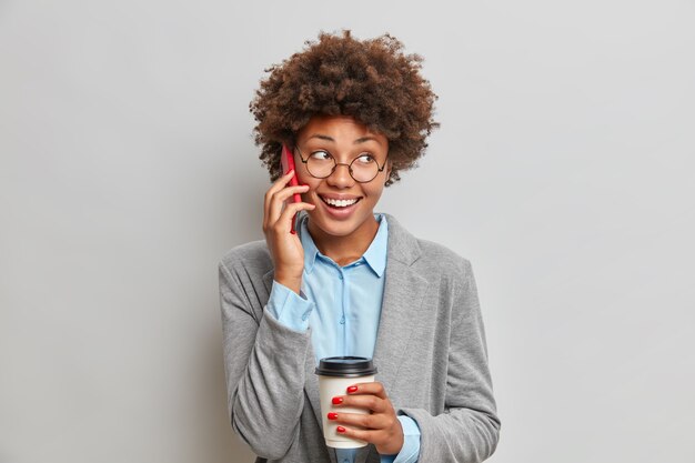 Foto grátis conceito de negócios e comunicação de pessoas. ainda bem que uma mulher afro-americana de pele escura tem uma conversa telefónica