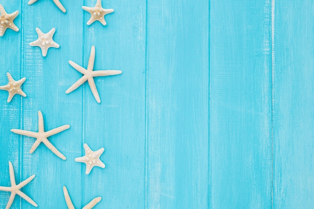 Conceito de verão com estrela do mar em um fundo azul de madeira com espaço de cópia