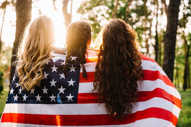 Foto grátis conceito do dia da independência com meninas na floresta por trás