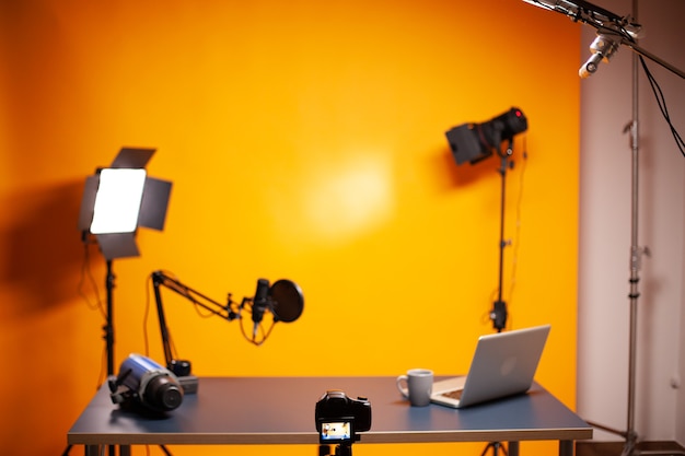 Configuração profissional de podcast e vlogging no estúdio com parede amarela