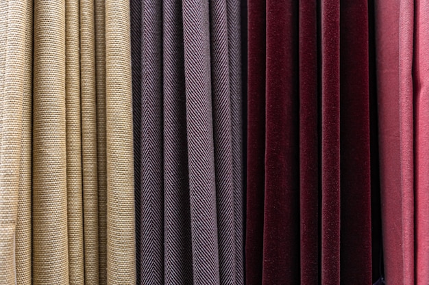 Conjunto de tecidos densos multicoloridos de textura uniforme, escolha de materiais em diferentes cores.