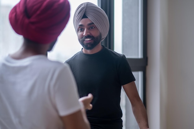 Conversação. dois homens de turbante conversando e parecendo envolvidos