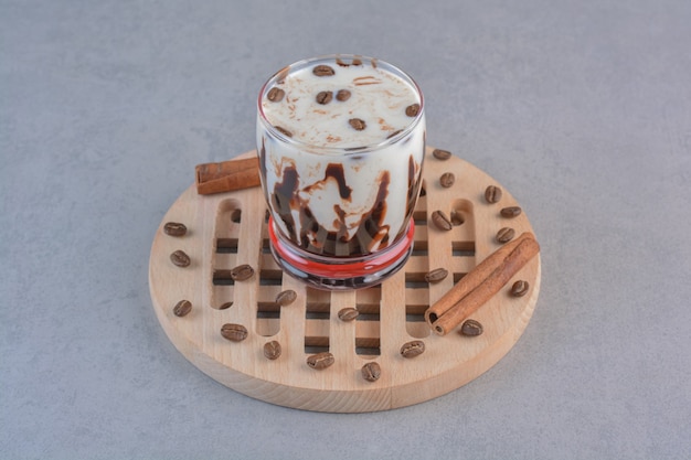 Copo de café gelado saboroso com leite na ferramenta de madeira.