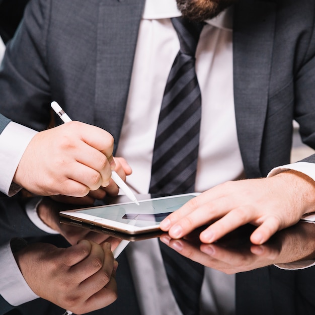 Foto grátis cortar homem usando e desenhando em tablet