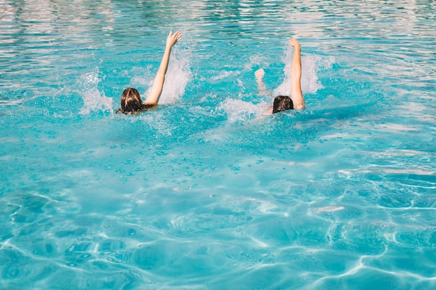 Couple swim backstroke