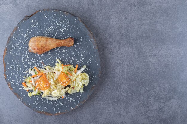 Coxinha de frango frito e salada na peça de madeira.