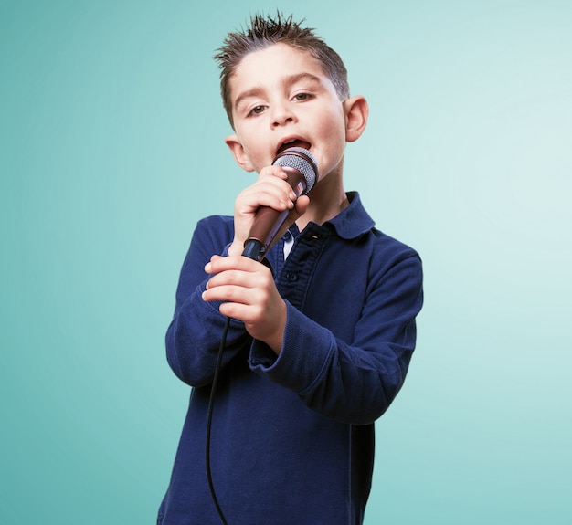 criança adorável cantando com um microfone
