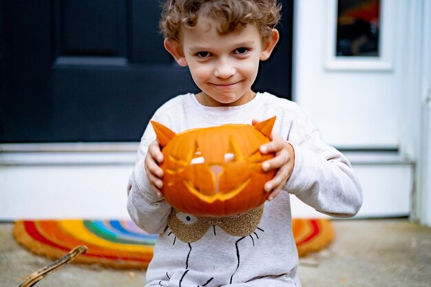 criança faz abóbora para o halloween