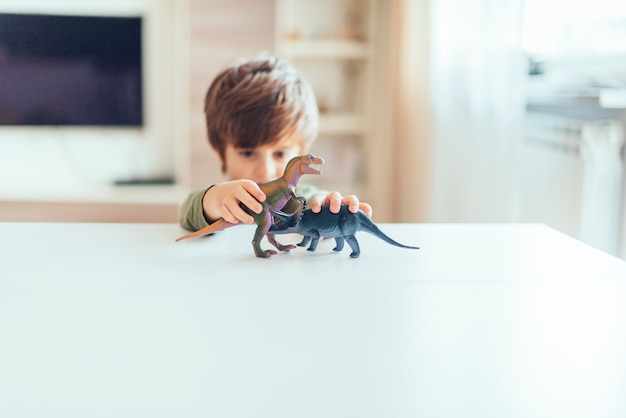 Foto grátis criança, tocando, com, brinquedo, dinossauros