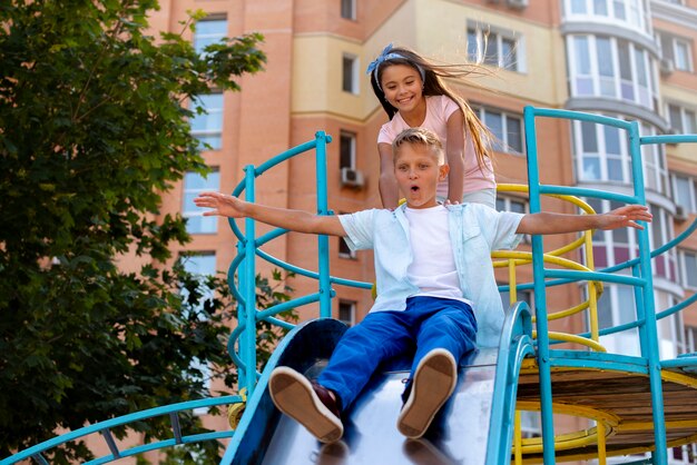 Crianças brincando em um slide no playground