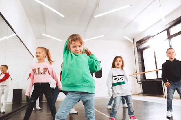 crianças na escola de dança. Dançarinos de balé, hiphop, rua, funky e modernos sobre o fundo do estúdio.