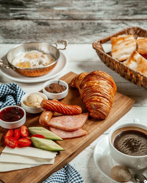 Foto grátis croissant fresco com salsicha frita e queijo