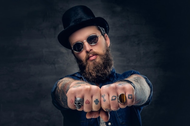 Foto grátis dedos do hipster tatuado close-up com anéis.