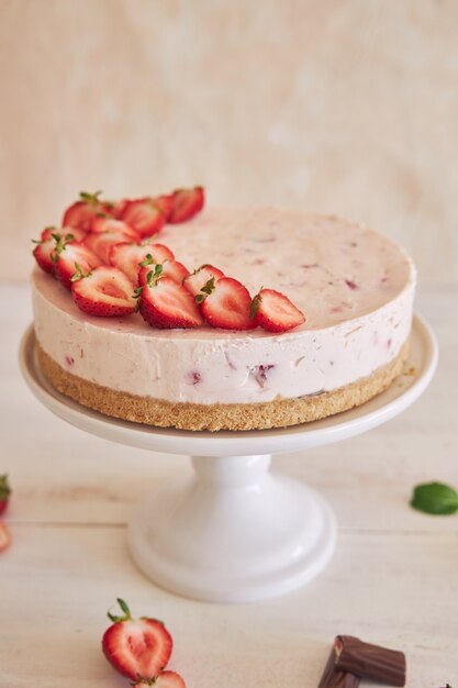 Delicioso bolo de iogurte gelado com fundo de biscoito e morangos