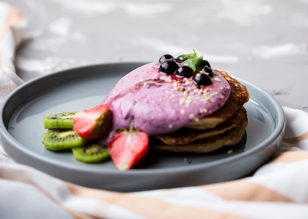 Foto grátis deliciosos crepes com metades de morango e kiwi