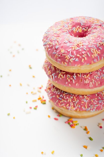 Deliciosos donuts empilhados com vidros e granulado