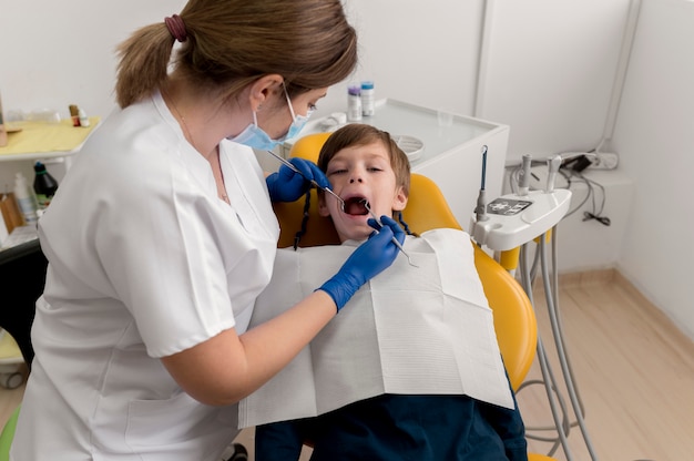 Dentista limpando dentes de criança